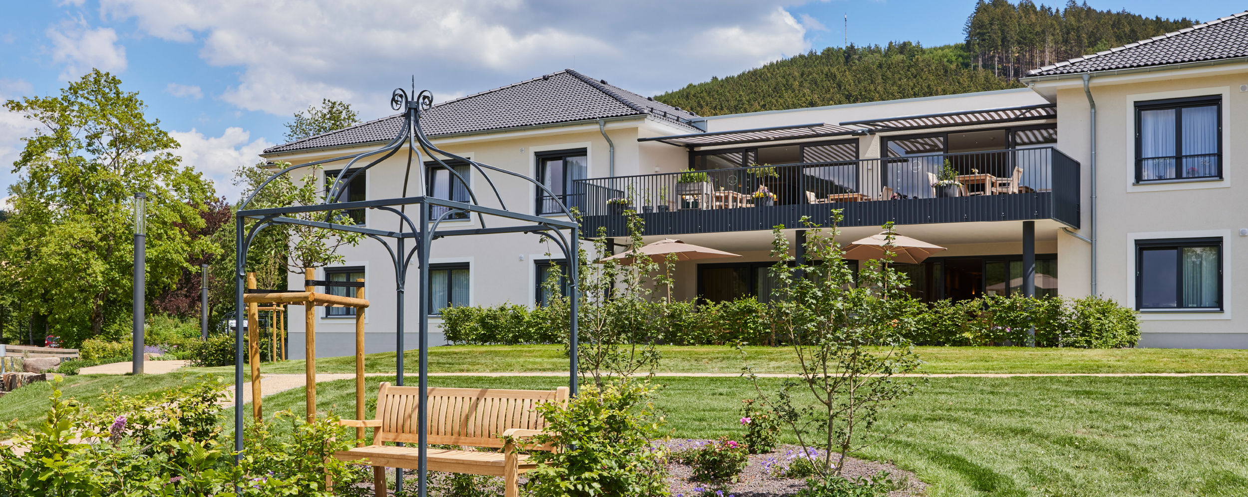 Außenansicht Gebäude Gemeinschafts-Wohnen und Parkanlage im WohnGut Saalhausen