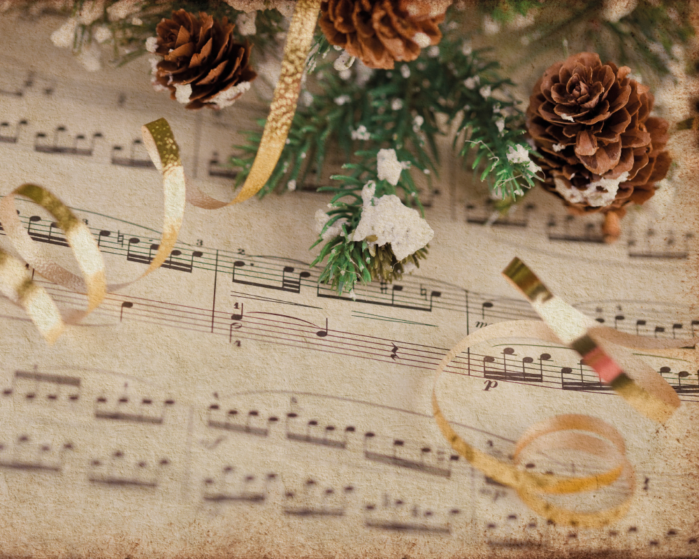 Notenheft mit Tannenzweigen und Tannenzapfen zu Weihnachten